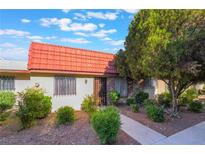 Charming single-story home featuring a red tile roof and well-manicured landscaping at 3925 Torsby Pl, Las Vegas, NV 89119