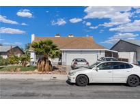 Charming single-story home with a two-car garage and low maintenance desert landscaping in the front yard at 4602 Inland Ct, Las Vegas, NV 89147