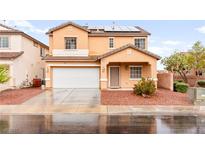 Charming two-story home with well-maintained lawn, two-car garage, and welcoming front porch at 6624 Jade Jaguar St, North Las Vegas, NV 89086