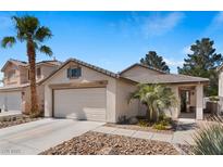 Charming single-Gathering home featuring desert landscaping, a two-car garage, and a welcoming front porch at 688 Castlebridge Ave, Las Vegas, NV 89123