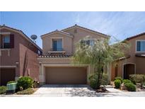 Two-story home features a cozy two-car garage and manicured landscaping at 7715 Peaceful Trellis Dr, Las Vegas, NV 89179