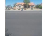 Charming single-story home featuring a red tile roof and a well-maintained front yard at 7894 W Patrick Ln, Las Vegas, NV 89113