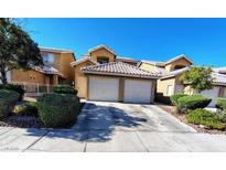 Inviting townhome with a tile roof, attached two-car garage, and manicured front yard in a well-kept community at 8072 Cimarron Ridge Dr # 201, Las Vegas, NV 89128