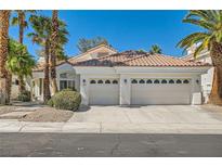 Beautiful single-story home showcasing a three-car garage, complemented by lush palm trees and attractive landscaping at 8124 Bay Harbor Dr, Las Vegas, NV 89128