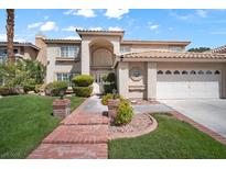 Inviting two-story home with mature landscaping and a brick walkway at 9404 Low Tide Ct, Las Vegas, NV 89117