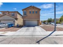 Two-story home featuring an attached two-car garage and low-maintenance landscaping at 9541 Vast Valley Ave, Las Vegas, NV 89148
