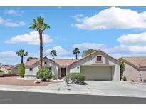 Charming single-story home with a two-car garage, desert landscaping, and mature palm trees at 9552 Gold Bank Dr, Las Vegas, NV 89134
