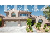 Inviting two-story home featuring a tile roof, a two-car garage, and desert landscaping at 11112 Pine Greens Ct, Las Vegas, NV 89144