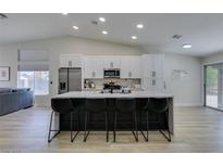 Bright kitchen featuring a large island with seating, stainless steel appliances, and lots of cabinet space at 1673 Golden Vista Dr, Las Vegas, NV 89123