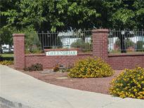 Inviting Greenbriar community entrance with well-maintained landscaping and brick signage at 171 Greenbriar Townhouse Way, Las Vegas, NV 89121