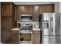 Updated kitchen features stainless steel appliances and dark wood cabinetry at 1782 Black Fox Canyon Rd, Henderson, NV 89052
