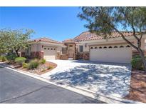 Charming single-story home with tile roof, desert landscaping, and a spacious three-car garage at 1963 Dakota Lodge Ave, Las Vegas, NV 89123
