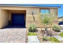 Charming single-story home featuring a well-maintained front yard and an attached two-car garage at 2719 Chinaberry Hill St, Laughlin, NV 89029