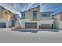Modern townhome showcasing contemporary architecture, neutral color palettes, and a convenient two-car garage at 3357 Via Tizzoni St, Henderson, NV 89044