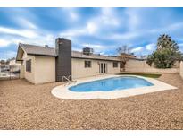 Backyard showcasing pool, rock landscaping and a partial view of home's exterior at 4450 San Rafael Ave, Las Vegas, NV 89120