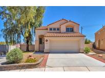 Charming home featuring a symmetrical facade, tile roof, and two-car garage at 4548 Switchback St, North Las Vegas, NV 89031