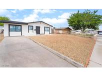 Charming single-story home with a well-maintained gravel yard and modern white and black trim at 50 Armstrong Cir, Henderson, NV 89015