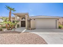 Charming single-story home with desert landscaping, inviting entrance, and a spacious two-car garage at 5000 Linkside Dr, Las Vegas, NV 89130