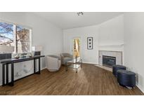 Bright living room featuring modern decor, a fireplace, and a sliding glass door at 5250 S Rainbow Blvd # 2106, Las Vegas, NV 89118