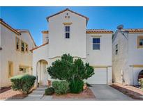 Charming two-story home with a white exterior and a well-manicured front yard in a residential neighborhood at 6271 Sunset Spring Ave, Las Vegas, NV 89122