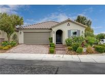 Charming single-story home with a tiled roof, two-car garage, and manicured landscaping at 7052 Blissful Peak St, North Las Vegas, NV 89084