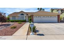 Charming single-story home featuring a well-manicured lawn and a two-car garage at 8761 Anchor Point Ave, Las Vegas, NV 89117