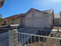 Single Gathering home with desert landscaping, and a two-car garage with driveway at 8813 Pavia Dr, Las Vegas, NV 89117