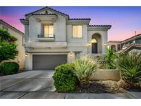 Charming two-story home showcasing desert landscaping, a two-car garage, and a classic stucco facade at 11908 Menchaca Ln, Las Vegas, NV 89138