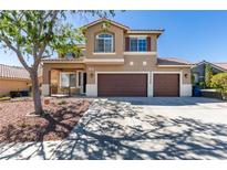 Charming two-story home featuring a three-car garage and well-maintained front yard at 189 Regal Sunset Ave, Henderson, NV 89002