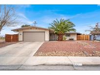 Charming single-story home with a well-maintained front yard and an attached two-car garage at 2559 Winterwood Blvd, Las Vegas, NV 89142