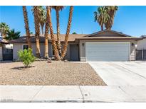 Charming single-story home with a two-car garage and desert landscaping at 3143 La Mesa Dr, Henderson, NV 89014