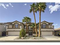Stunning two-story home featuring a three-car garage, balconies, and meticulously manicured front yard with palm trees at 386 Wiseton Ave, Las Vegas, NV 89183