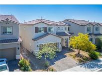 Inviting two-story home with a well-manicured front yard and a charming, neutral-toned exterior at 4634 Observed St, North Las Vegas, NV 89031