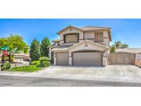 Stunning two-story home featuring a three-car garage, desert landscaping, and neutral color palette at 6301 Citrine Ave, Las Vegas, NV 89130
