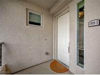 Entry to unit 401 featuring white door, small window, and a view through the side window at 9201 Tesoras Dr # 401, Las Vegas, NV 89144