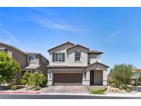 Charming two-story home featuring a manicured lawn and inviting two-car garage at 9430 Isla Lee Ave, Las Vegas, NV 89178