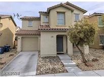 Inviting two-story home with a well-maintained lawn, desert landscaping, and an attached one car garage at 11882 Snow Bank St, Las Vegas, NV 89183