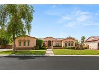 Charming single-story home featuring a well-manicured lawn, arched windows, and a symmetrical facade at 215 Great Gable Dr, Las Vegas, NV 89183