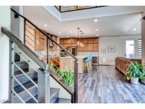 Open floor plan with modern kitchen featuring stainless steel appliances and a breakfast bar with seating at 2637 Via Monet, Henderson, NV 89044