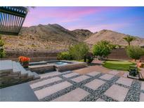 Stunning backyard with pool, jacuzzi, putting green, and mountain views at 2927 The Peaks Ln, Las Vegas, NV 89138