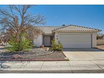 Single-story home featuring desert landscaping, a tile roof, and an attached two-car garage at 3912 Branchwood Dr, North Las Vegas, NV 89032