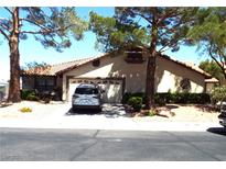 Charming single-story home featuring a tile roof, two-car garage and mature landscaping at 3954 Saddlewood Ct, Las Vegas, NV 89121