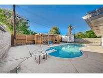 Backyard pool area featuring diving board, mature trees, and shaded outdoor entertaining space at 4284 Parkdale Ave, Las Vegas, NV 89121