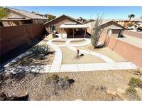 Charming backyard featuring desert landscaping, including decorative succulents and a covered patio for relaxing outdoors at 5019 Quiet Falls Ct, Las Vegas, NV 89141