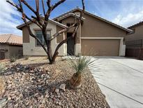 Inviting single-story home with a two-car garage and desert landscaping at 5019 Quiet Falls Ct, Las Vegas, NV 89141