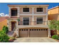 Two-story home featuring a spacious two car garage and a small balcony at 5448 Tulip Hill Ave, Las Vegas, NV 89141