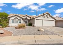 Charming single-story home featuring a two-car garage and low maintenance desert landscaping in front at 556 Decidedly St, Henderson, NV 89015
