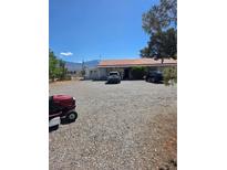 Cozy single-story home featuring a large gravel driveway and mountain views at 626 Kimberly Ave, Pahrump, NV 89060