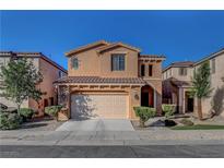 Charming two-story home with a tile roof, complemented by a well-manicured front yard and an attached two-car garage at 644 Mauna Kea Pl, Henderson, NV 89011