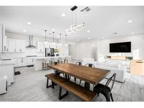 Bright living room features sleek, modern decor and an open-concept design with luxury finishes at 717 Monroe Hill Pl, Henderson, NV 89011